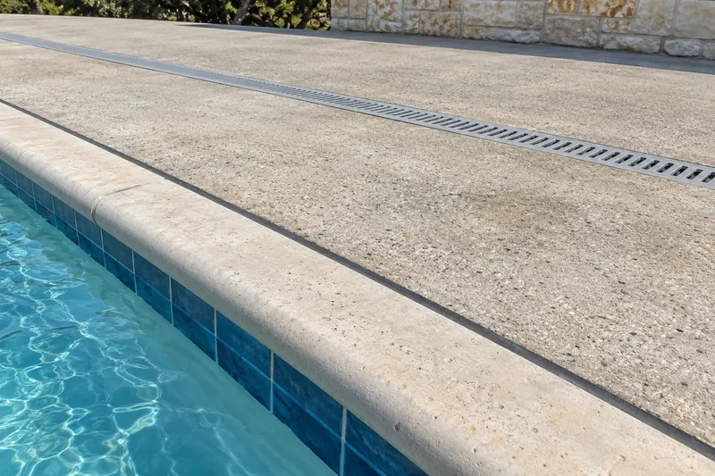 Expansion joint and trench drain on a commercial pool deck
