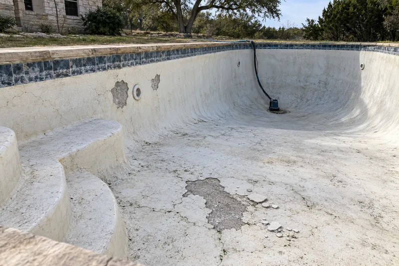 Plaster popped off to bare gunite in a drained pool