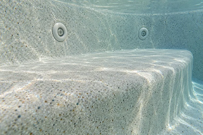 Resurfaced spa bench seat and jets under clear water