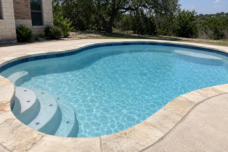 Backyard pool with new white plaster and bright light blue water